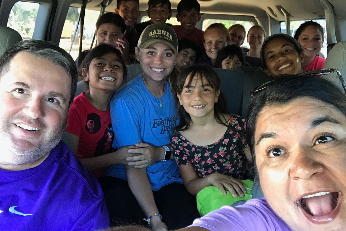 Softball students and coaches on a bus in the Baja