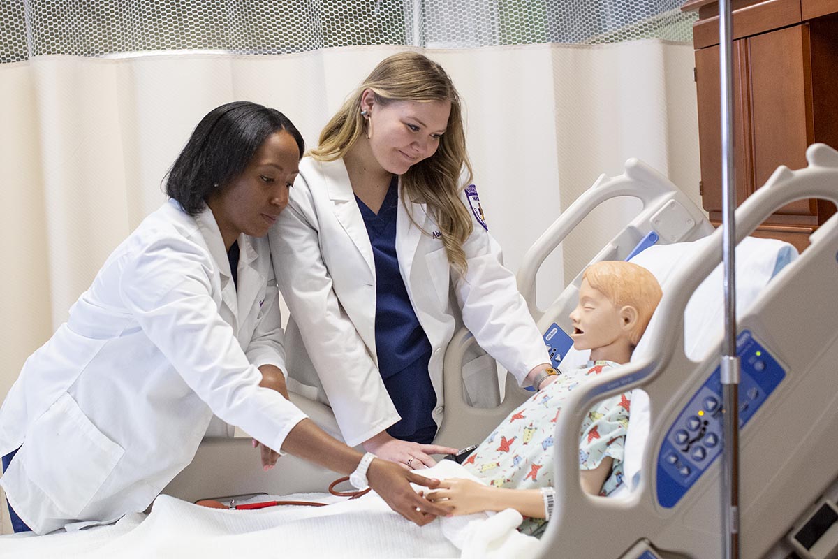 Abbey Ward and another nursing student in simulation lab