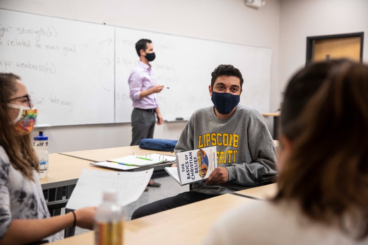 Students with Josh Strahan's book in class