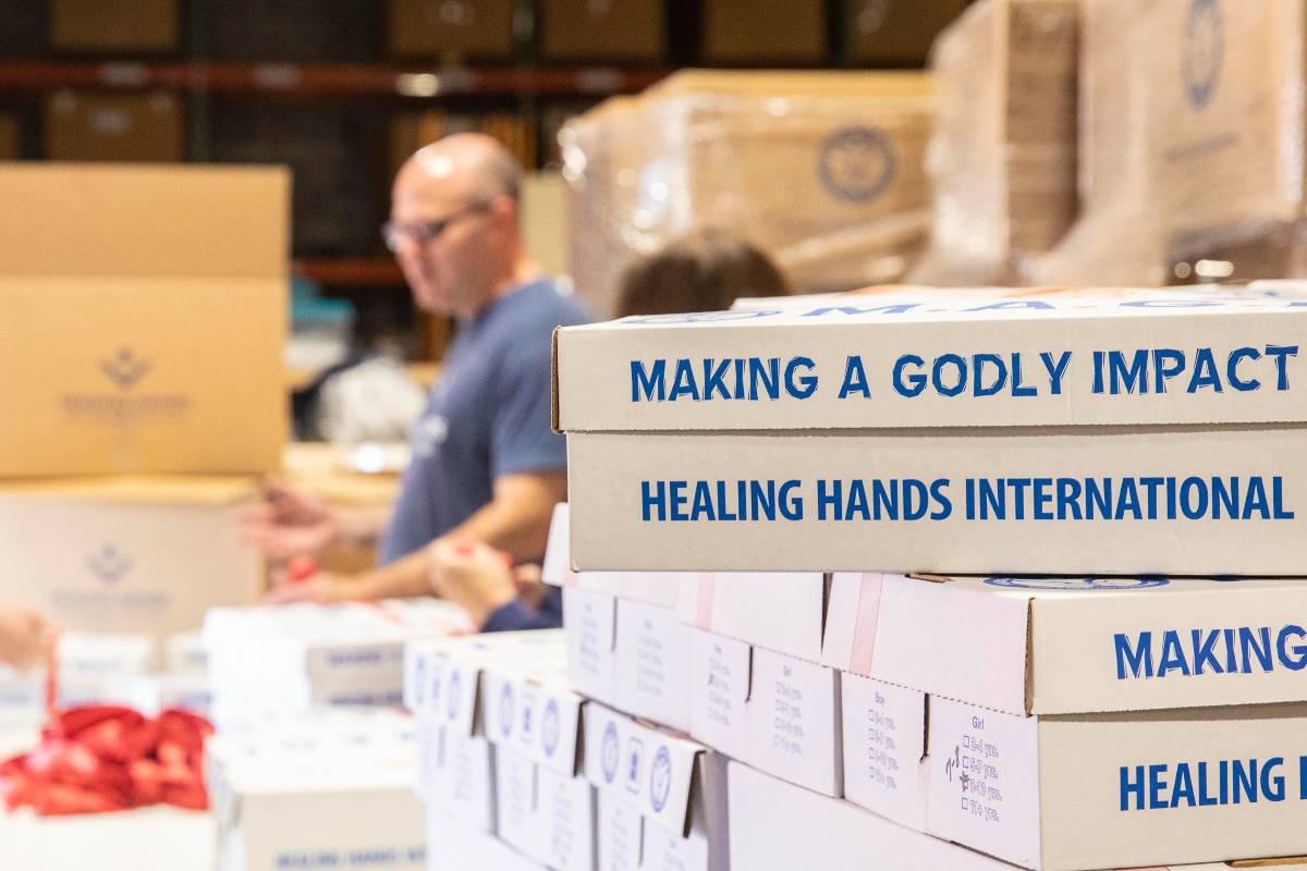 Healing Hands employees packing MAGI boxes