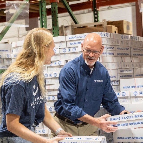 Healing Hands employees packing MAGI boxes