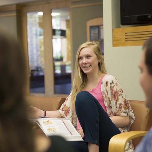 Student talks with others in Bennett Campus Center