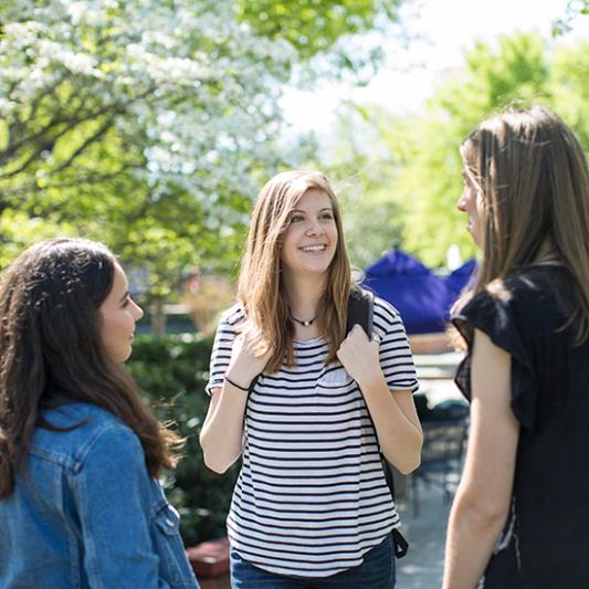 Three female students talking together outside at Lipscomb