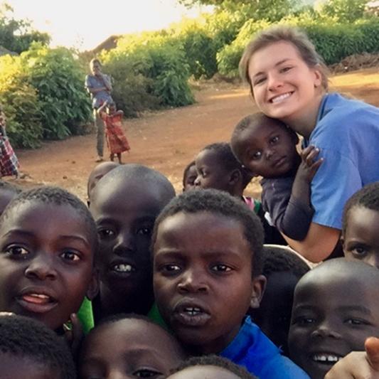 A student health professional with children in Malawi
