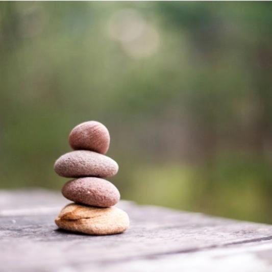 Four stacked rocks in nature