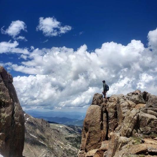 Zeke Cutts standing on a mountain 