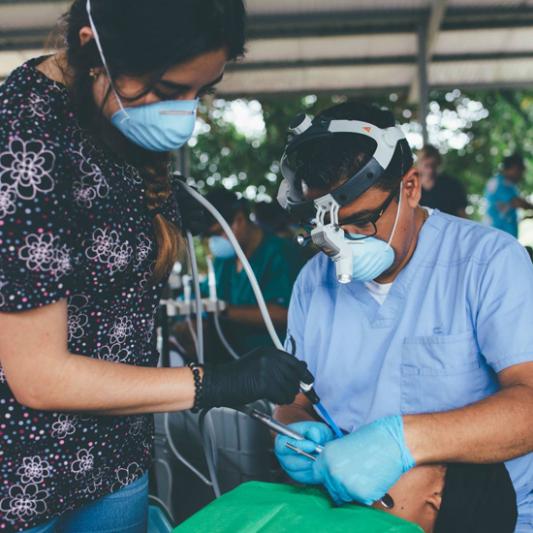 A professional dentist and a Lipscomb nursing student work in a mobile clinic in Guatemala.