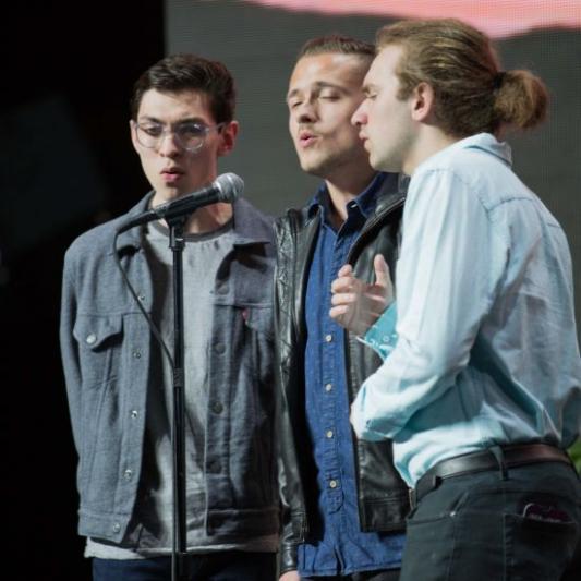 Three students singing