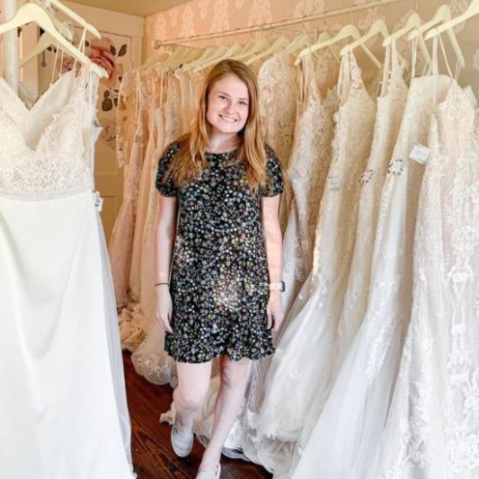 Designer with wedding dresses