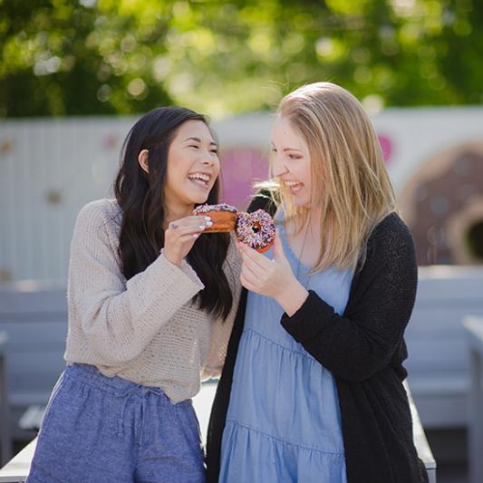 Two young women students with Five Daughters Donuts