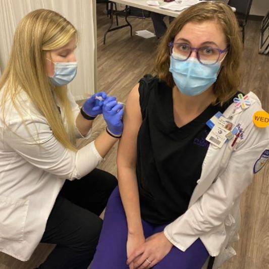Pharmacy student administers a covid vaccine