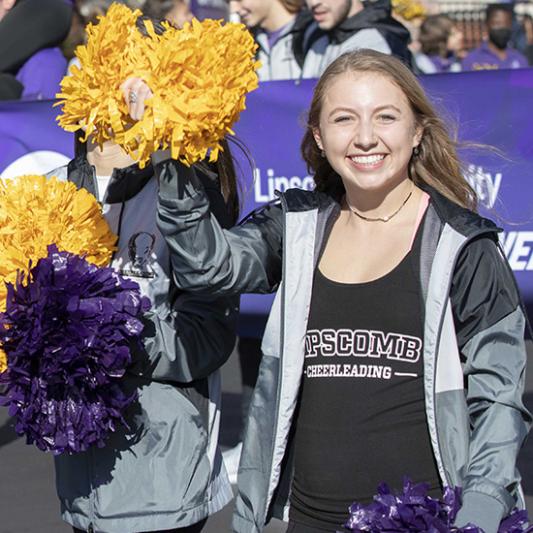 Cheerleader with pom poms at a Lipscomb game