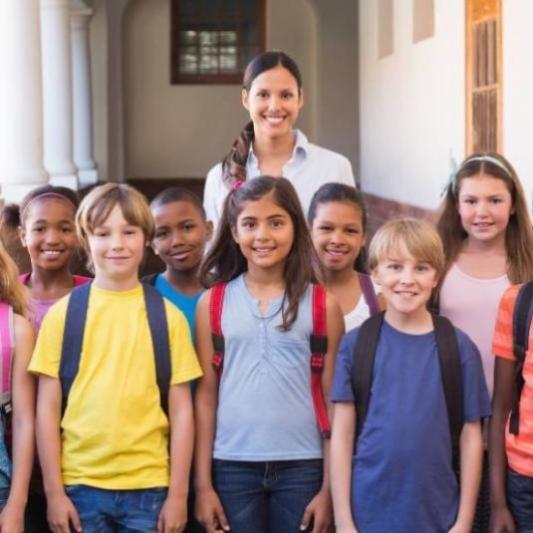 Teacher with her students outside in a hallway