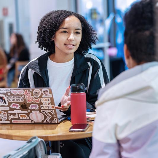 Students talking at coffee shop.