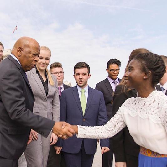 A student meets Rep. John Lewis on the steps of the U.S. Capitol