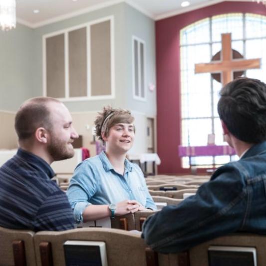 Students sitting in church pews