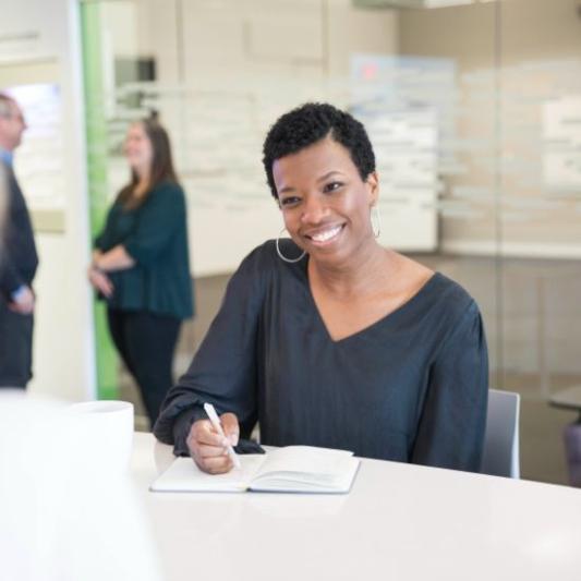 woman writing and smiling