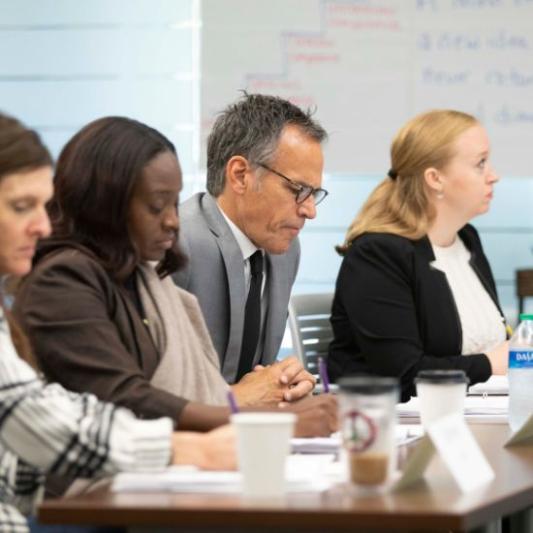 graduate students listening and working in class
