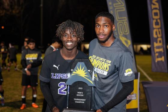 Malachi Jones (left) and Tyrese Spicer (right) with ASUN Championship trophy